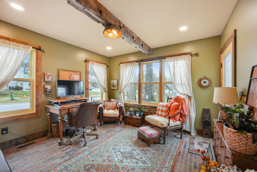 Mid-sized country study room in Columbus with green walls, brick floors, a freestanding desk, red floor and exposed beam.