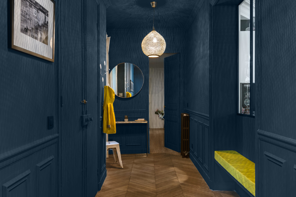 Mid-sized transitional foyer in Paris with blue walls, light hardwood floors, a double front door and a blue front door.