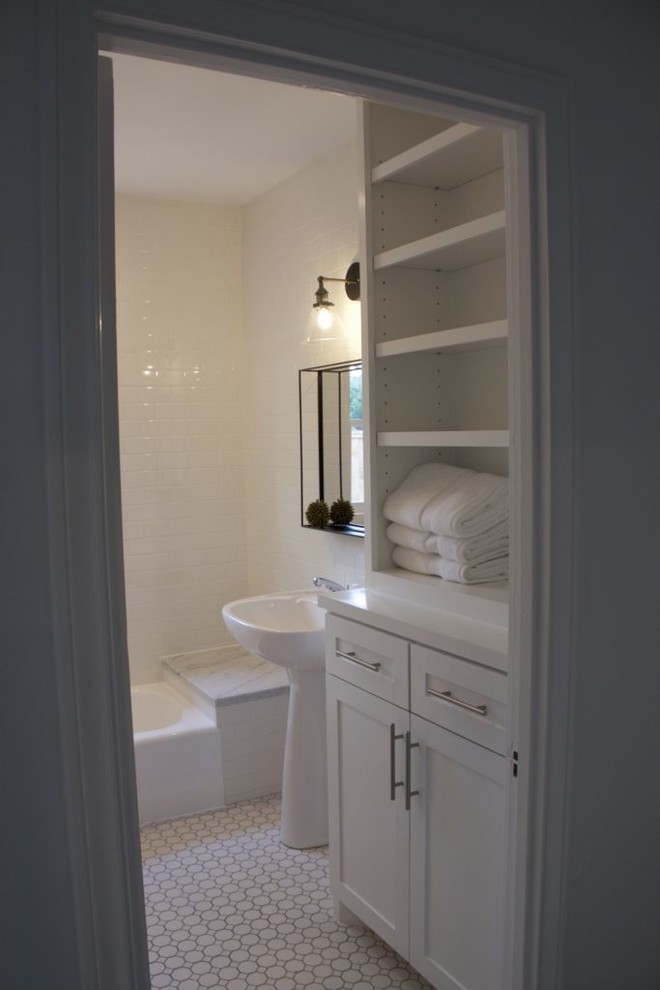 Inspiration for a mid-sized traditional 3/4 bathroom in Houston with shaker cabinets, white cabinets, an alcove tub, white tile, subway tile, white walls, ceramic floors, a pedestal sink, white floor and a hinged shower door.