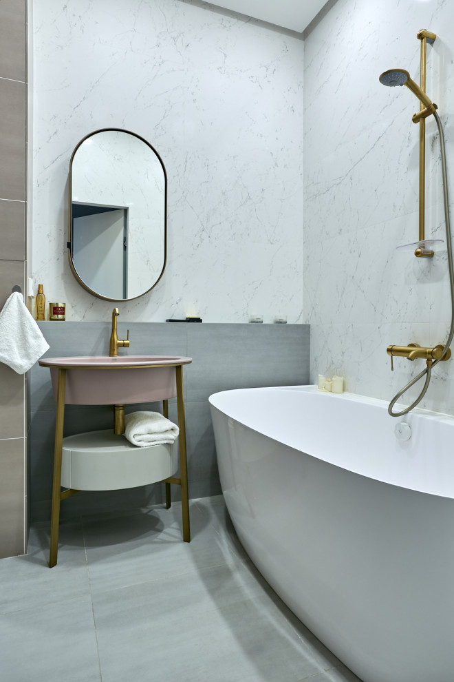 Photo of a small contemporary master bathroom in Moscow with flat-panel cabinets, white cabinets, a freestanding tub, a shower/bathtub combo, white tile, gray tile, pink tile, an integrated sink, grey floor, a double vanity, a freestanding vanity and porcelain floors.