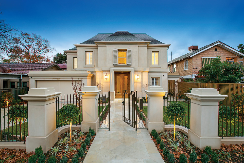 This is an example of a transitional two-storey beige exterior in Melbourne with a hip roof.