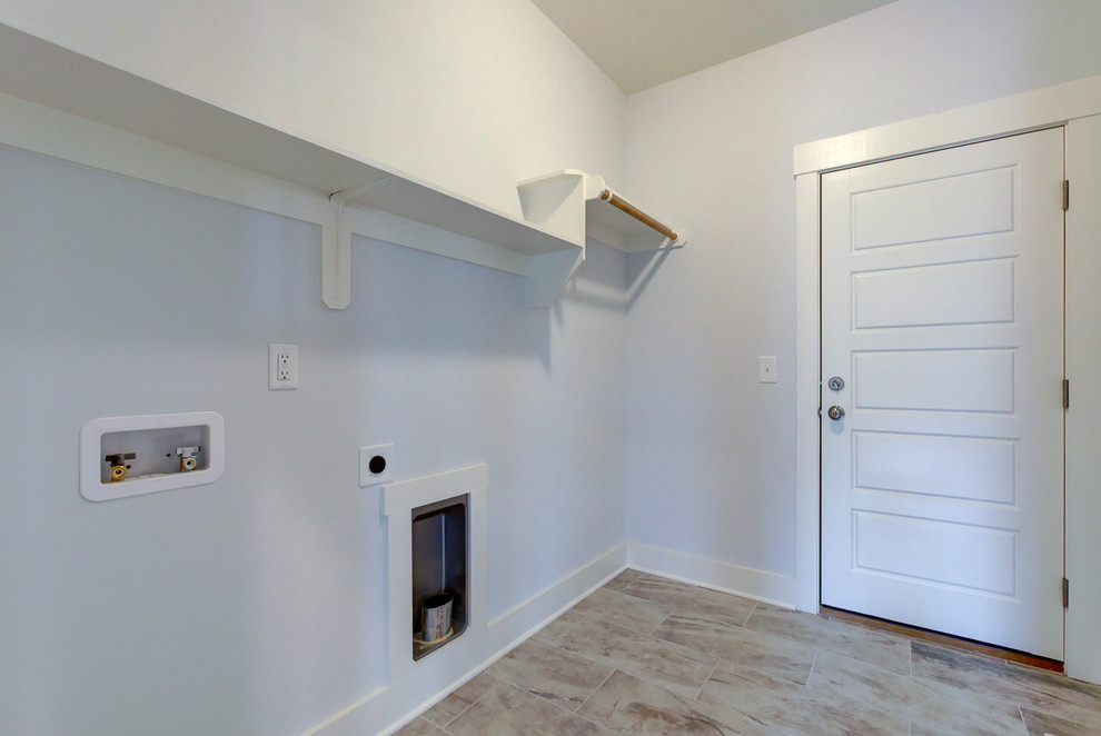 Design ideas for a mid-sized arts and crafts single-wall dedicated laundry room in Raleigh with grey walls, porcelain floors, a side-by-side washer and dryer and grey floor.