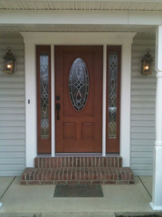 Front door - small front door idea with a medium wood front door