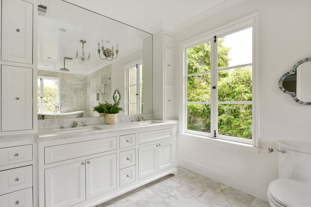 Inspiration for a mid-sized mediterranean 3/4 porcelain tile, gray floor and double-sink bathroom remodel in San Francisco with shaker cabinets, white cabinets, a one-piece toilet, white walls, an undermount sink, gray countertops and a built-in vanity