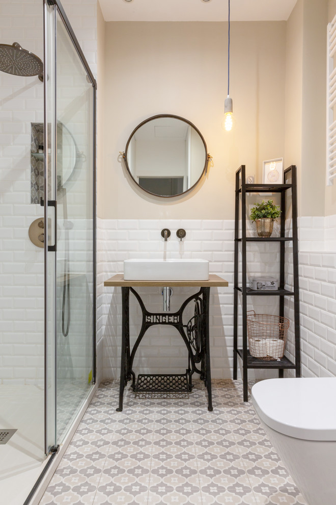 This is an example of a scandinavian 3/4 bathroom in Madrid with open cabinets, an alcove shower, white tile, subway tile, beige walls, a vessel sink, wood benchtops, beige floor, a sliding shower screen and brown benchtops.