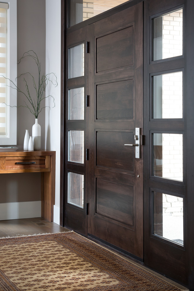 Inspiration for a mid-sized transitional front door in Calgary with grey walls, vinyl floors, a single front door and a dark wood front door.