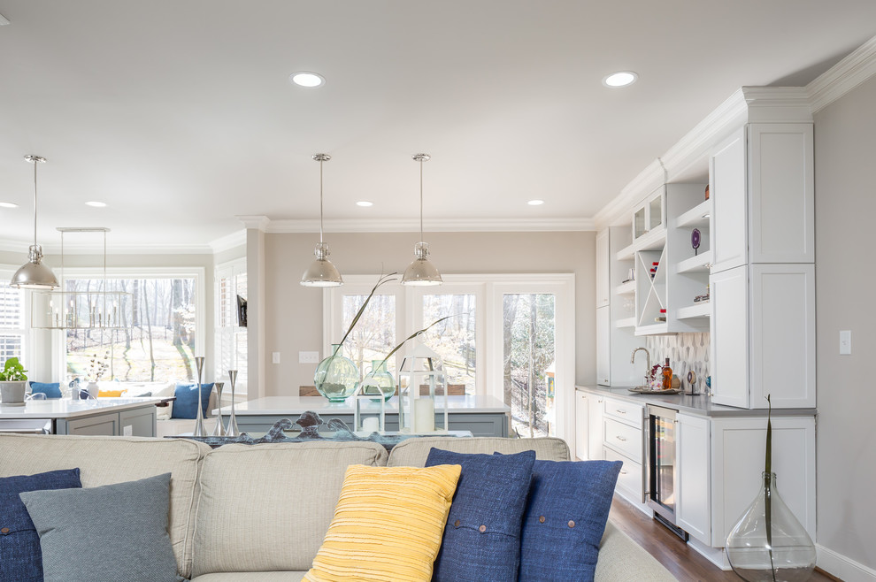 Huge transitional galley medium tone wood floor open concept kitchen photo in Raleigh with a farmhouse sink, flat-panel cabinets, white cabinets, quartz countertops, gray backsplash, ceramic backsplash, stainless steel appliances and two islands