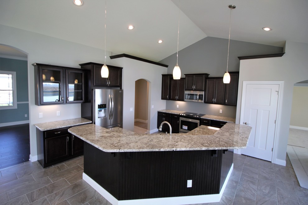 Transitional l-shaped eat-in kitchen in Other with black cabinets, granite benchtops, stainless steel appliances, ceramic floors and with island.