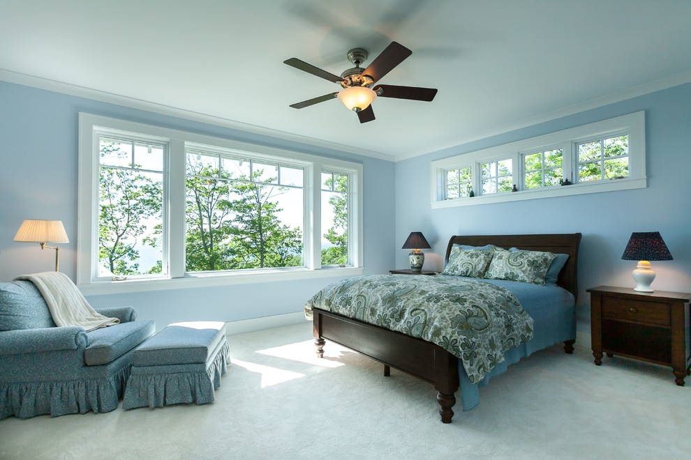 Inspiration for a large arts and crafts master bedroom in Other with blue walls and carpet.