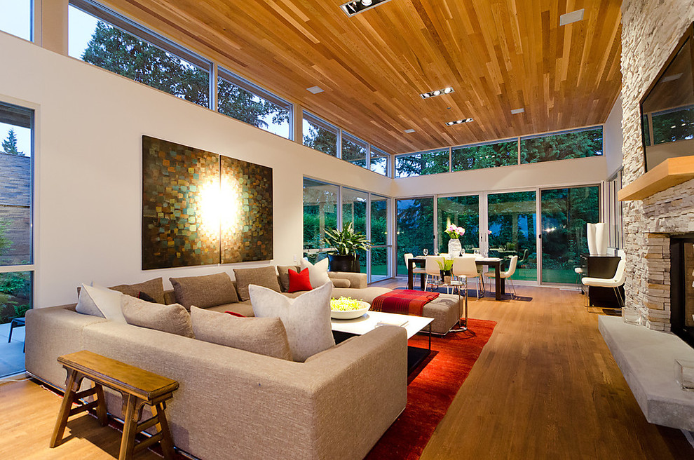 Inspiration for a contemporary living room remodel in Seattle with a stone fireplace and a wall-mounted tv