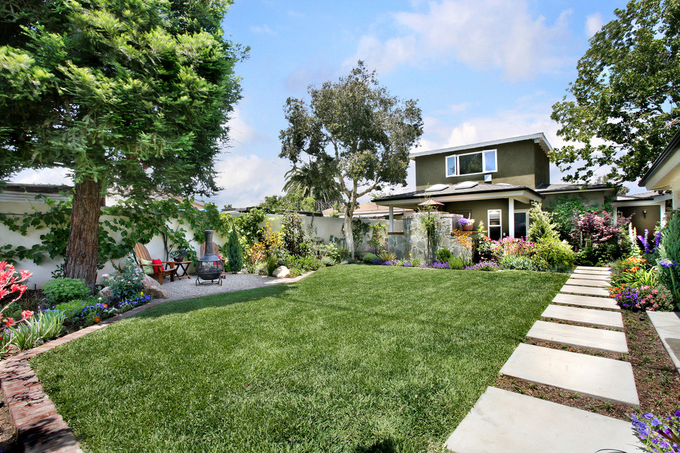 Mid-sized traditional backyard full sun formal garden in Orange County with concrete pavers and with lawn edging.