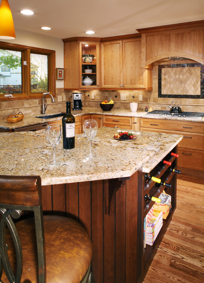Kitchen with recessed-panel cabinets, medium wood cabinets and granite benchtops.