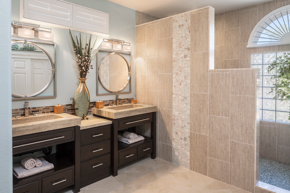Inspiration for a mid-sized asian master bathroom in Las Vegas with dark wood cabinets, limestone benchtops, an open shower, a one-piece toilet, beige tile, porcelain tile, green walls, porcelain floors, an integrated sink and flat-panel cabinets.