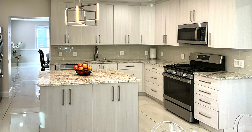 Photo of a large contemporary kitchen in Baltimore with an undermount sink, flat-panel cabinets, beige cabinets, quartzite benchtops, beige splashback, glass tile splashback, stainless steel appliances, porcelain floors, with island, white floor and multi-coloured benchtop.