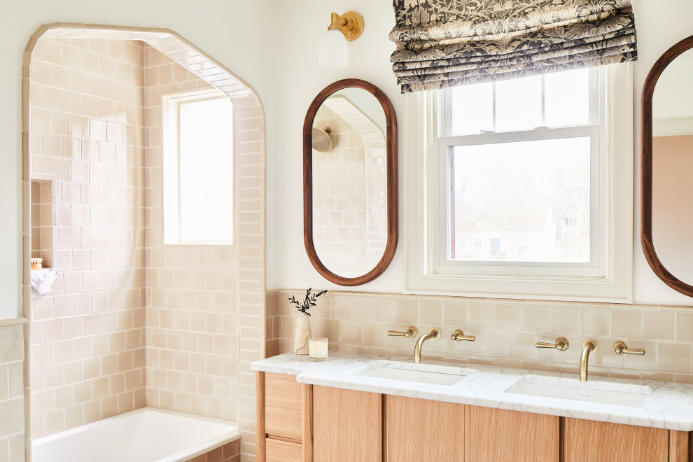 Traditional master bathroom in San Francisco with flat-panel cabinets, light wood cabinets, a drop-in tub, beige tile, an undermount sink, white benchtops, a double vanity and a niche.