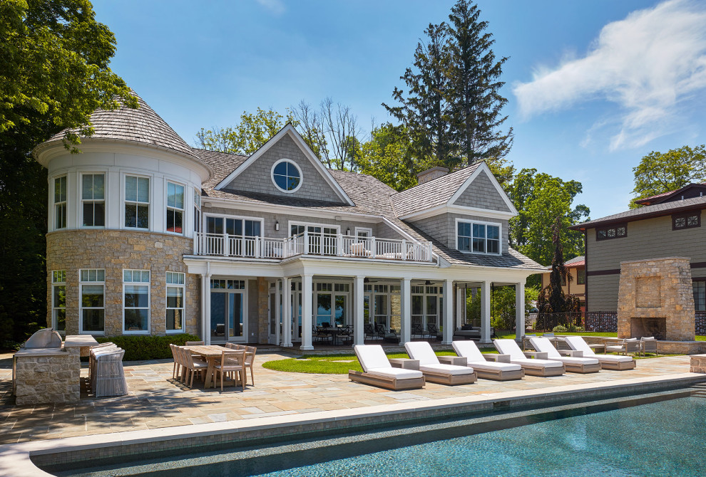 Lakehouse Lux - Coastal gray two-story mixed siding and shingle house exterior idea in Chicago with a shingle roof and a brown roof