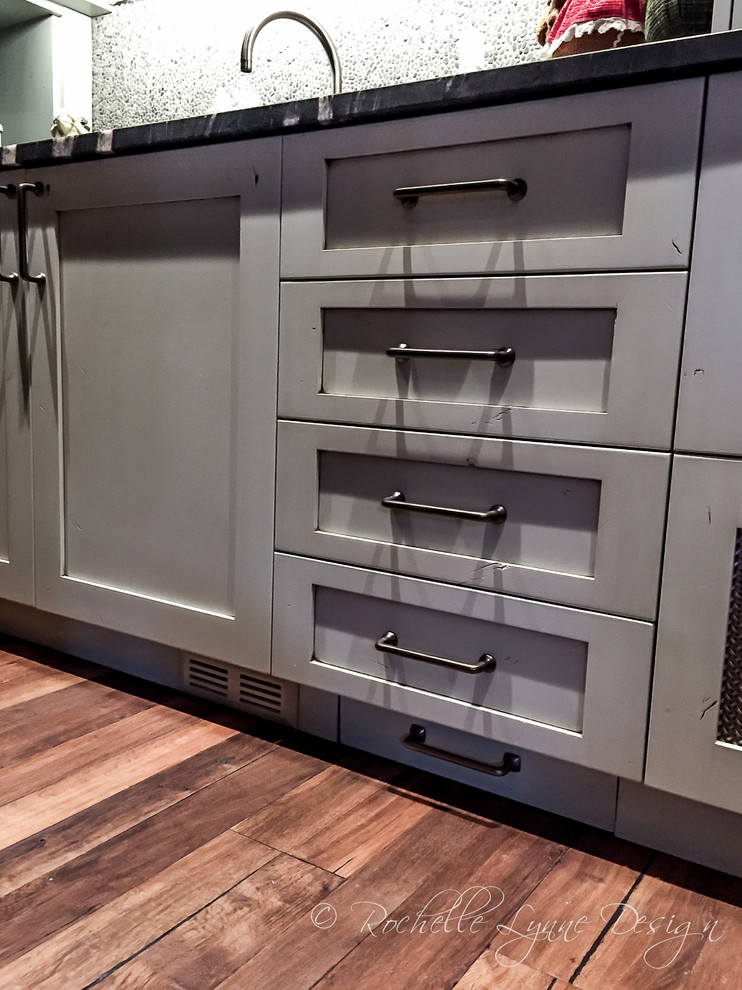 Kitchen pantry - rustic u-shaped medium tone wood floor kitchen pantry idea in Calgary with shaker cabinets, distressed cabinets, granite countertops, gray backsplash and mosaic tile backsplash