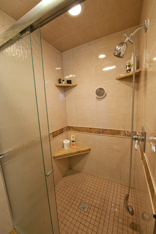 Inspiration for a large transitional master brown tile and ceramic tile ceramic tile alcove shower remodel in Indianapolis with an undermount sink, recessed-panel cabinets, black cabinets, granite countertops, a two-piece toilet and beige walls