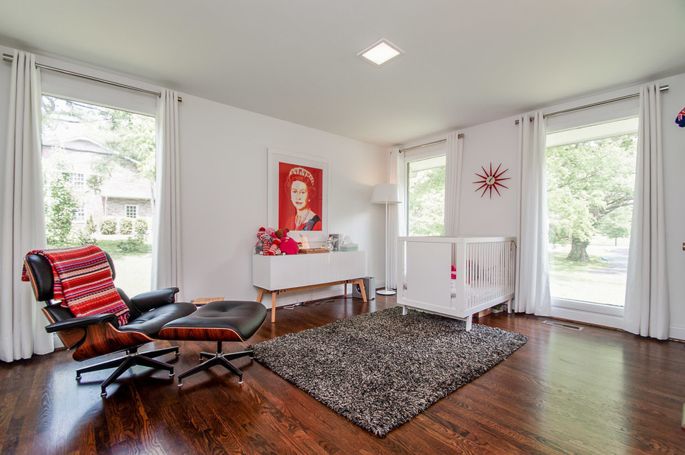 Mid-sized contemporary gender-neutral nursery in Nashville with white walls, dark hardwood floors and brown floor.