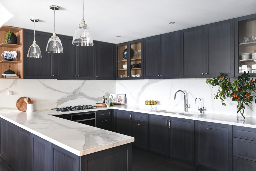 Kitchen - small contemporary u-shaped porcelain tile and black floor kitchen idea in Sydney with an undermount sink, shaker cabinets, blue cabinets, porcelain backsplash, black appliances and a peninsula