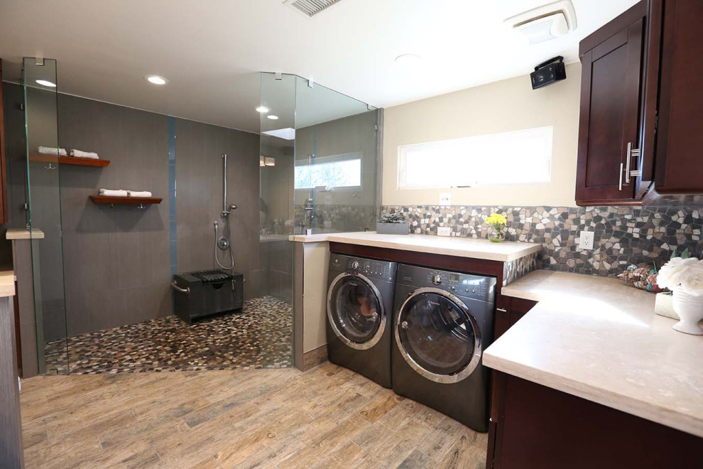 This is an example of a large retro ensuite bathroom in San Diego with shaker cabinets, dark wood cabinets, a corner shower, multi-coloured tiles, beige walls, medium hardwood flooring, a submerged sink, brown floors, an open shower, beige worktops, a laundry area, double sinks and a built in vanity unit.