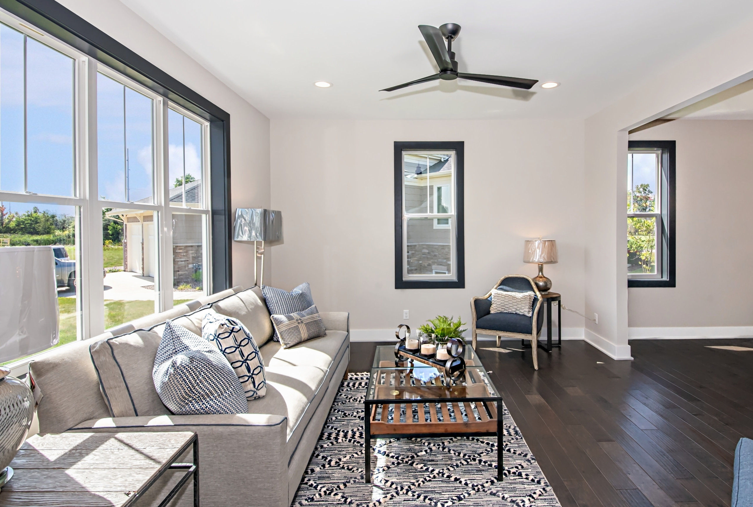 Open concept dark wood floor family room photo in Other