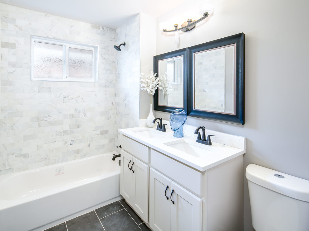Example of a mid-sized transitional alcove bathtub design with shaker cabinets, white cabinets, a one-piece toilet, gray walls and an undermount sink