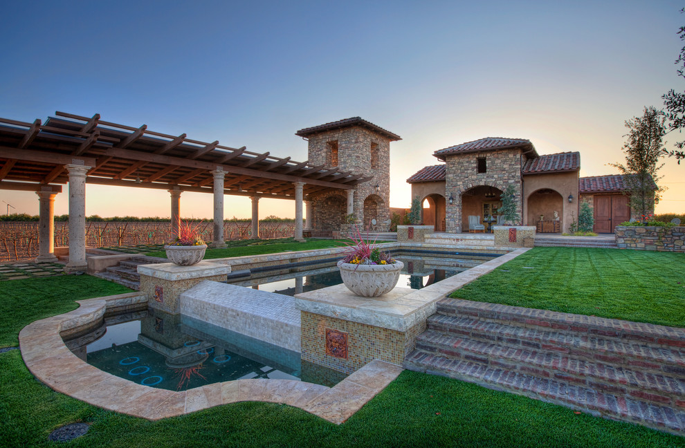 Design ideas for an expansive mediterranean backyard full sun garden for summer in Other with natural stone pavers.