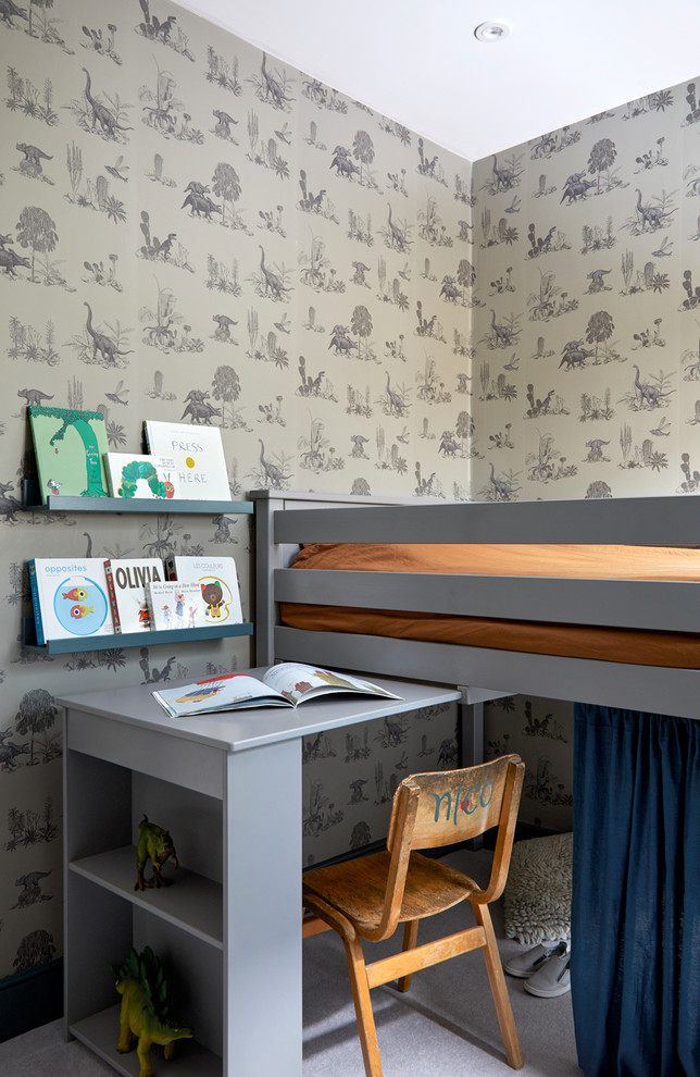 This is an example of a small contemporary kids' bedroom for kids 4-10 years old and boys in London with blue walls, carpet and grey floor.