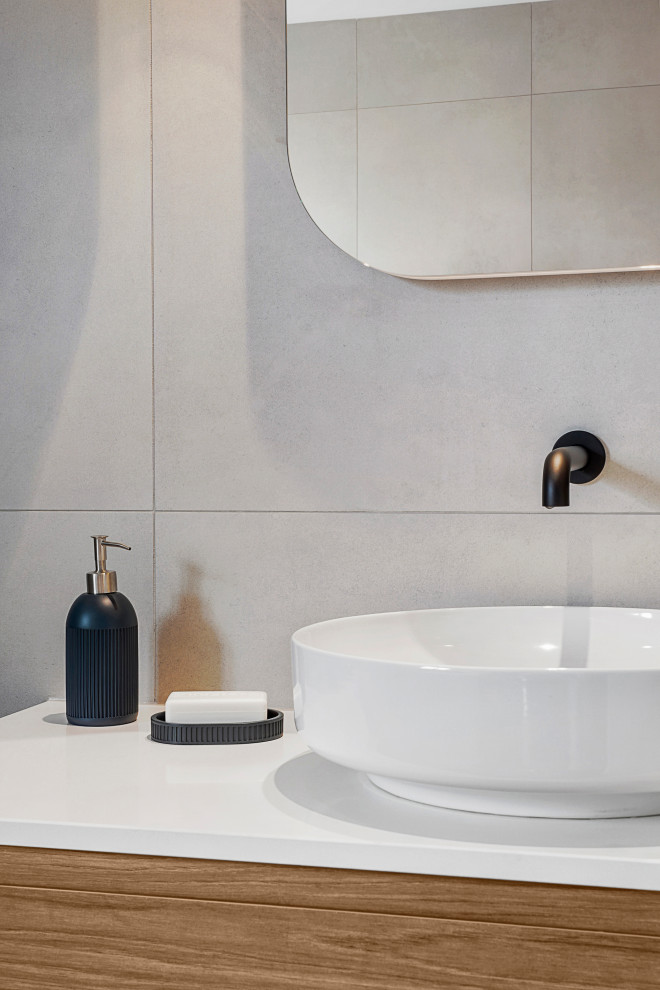 Inspiration for a mid-sized contemporary bathroom in Melbourne with gray tile and porcelain tile.