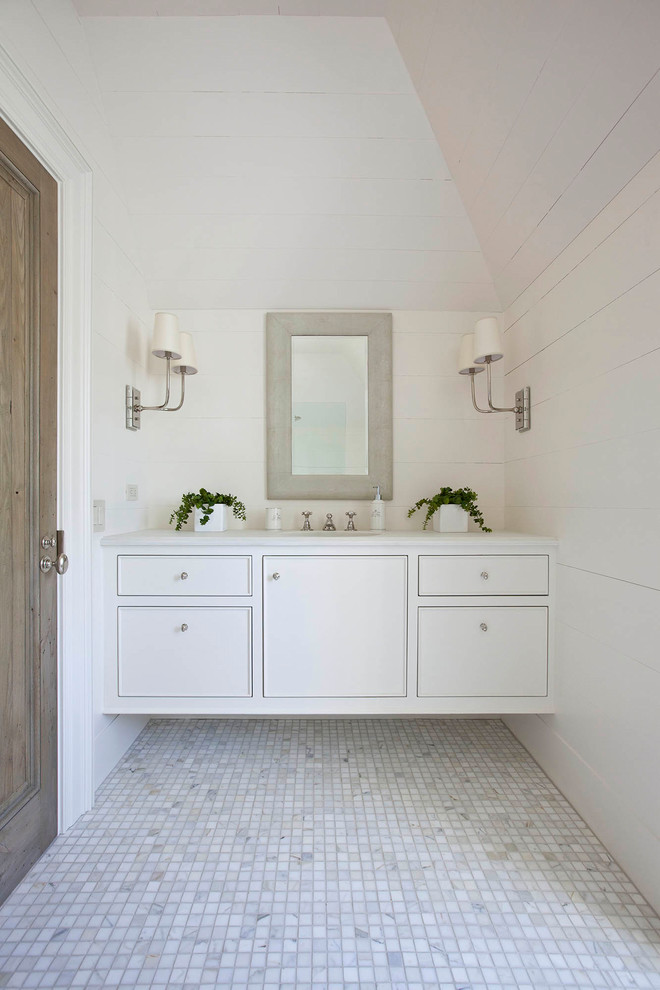 Design ideas for a mid-sized country 3/4 bathroom in Charlotte with beaded inset cabinets, white cabinets, white tile, white walls, marble floors, an undermount sink, engineered quartz benchtops and white floor.