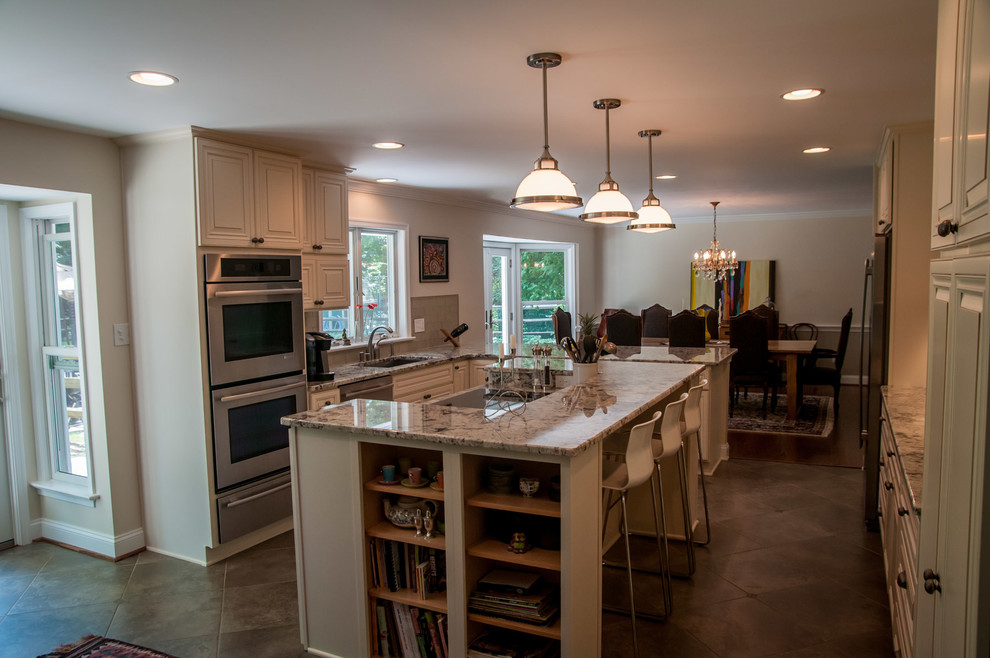 Traditional u-shaped eat-in kitchen in Philadelphia with an undermount sink, recessed-panel cabinets, white cabinets, granite benchtops, green splashback, glass tile splashback and stainless steel appliances.