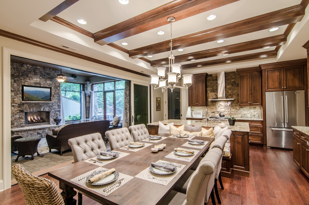 Design ideas for an expansive transitional kitchen/dining combo in Other with white walls, medium hardwood floors, a standard fireplace and a stone fireplace surround.