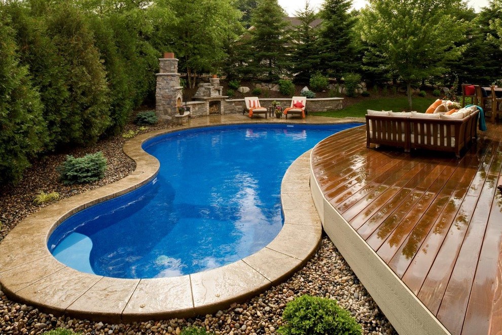 Traditional pool in Minneapolis with decking.