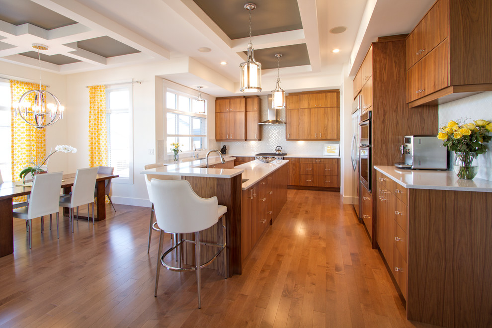 Large minimalist l-shaped medium tone wood floor eat-in kitchen photo with an undermount sink, flat-panel cabinets, medium tone wood cabinets, quartz countertops, white backsplash, ceramic backsplash, stainless steel appliances and an island