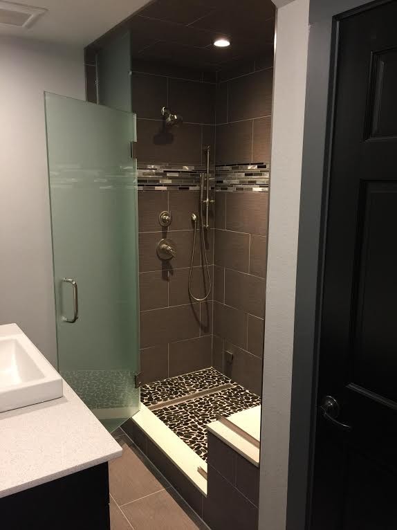 Design ideas for a mid-sized contemporary 3/4 bathroom in Other with black cabinets, a corner shower, ceramic tile, grey walls, ceramic floors, a vessel sink, solid surface benchtops, multi-coloured tile and a hinged shower door.