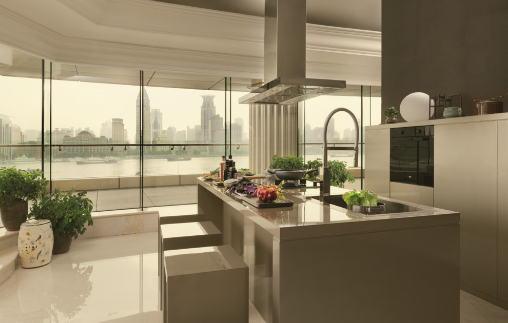 Small modern kitchen in Singapore with stainless steel appliances and a single-bowl sink.