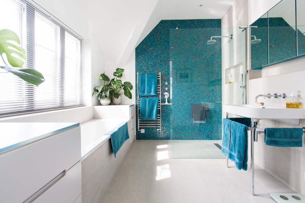 Mid-sized contemporary master bathroom in London with a drop-in tub, an open shower, a wall-mount toilet, blue tile, ceramic tile, black walls, ceramic floors, a wall-mount sink, white floor and an open shower.