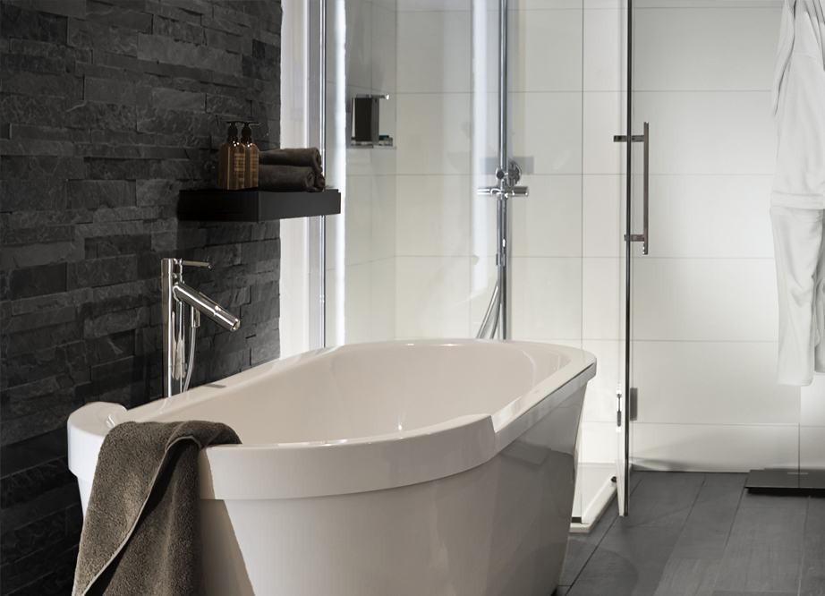 Inspiration for a large modern master bathroom in Chicago with a freestanding tub, a corner shower, a one-piece toilet, multi-coloured walls, medium hardwood floors, a vessel sink, flat-panel cabinets, dark wood cabinets, stone tile, white tile and wood benchtops.