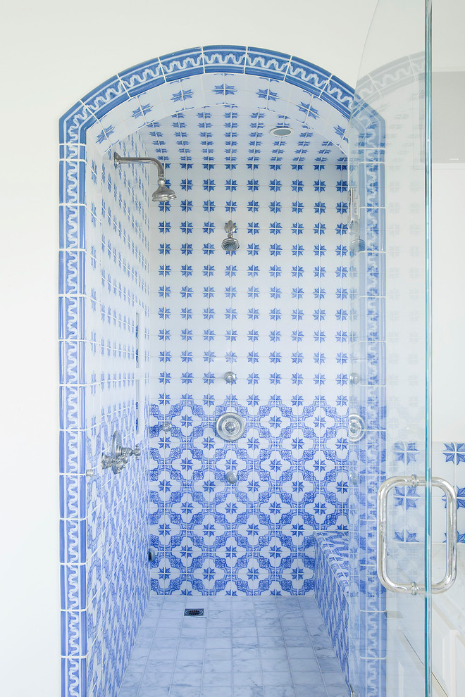 Mediterranean bathroom in Los Angeles with an alcove shower, white walls and blue tile.