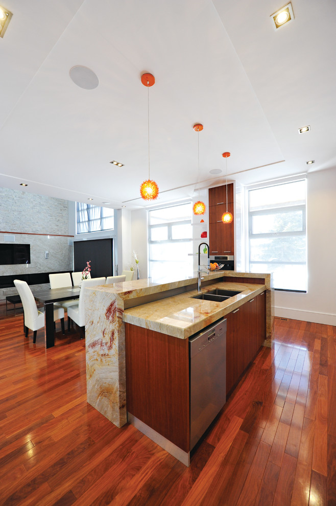 Eat-in kitchen - mid-sized transitional single-wall medium tone wood floor eat-in kitchen idea in Toronto with a double-bowl sink, flat-panel cabinets, medium tone wood cabinets, granite countertops, multicolored backsplash, stone slab backsplash, stainless steel appliances and an island