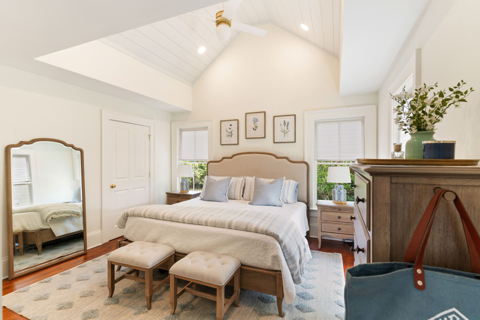Photo of a mid-sized traditional master bedroom in Atlanta with white walls, medium hardwood floors, brown floor and vaulted.