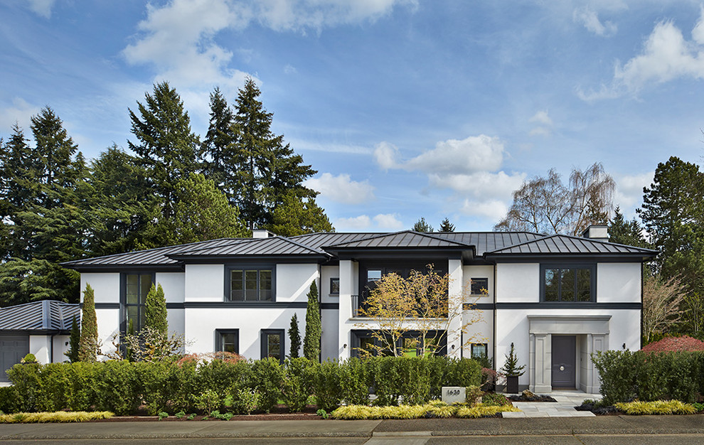 Photo of a transitional two-storey stucco white exterior in Seattle.