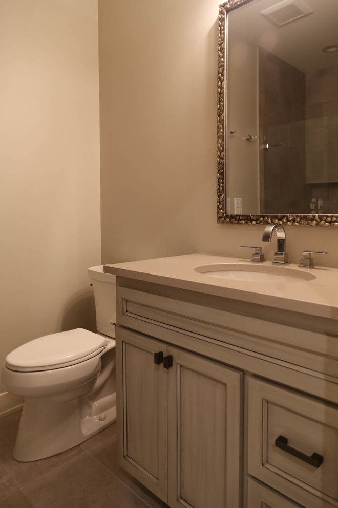 Inspiration for a mid-sized transitional kids' bathroom remodel with raised-panel cabinets, light wood cabinets and quartzite countertops
