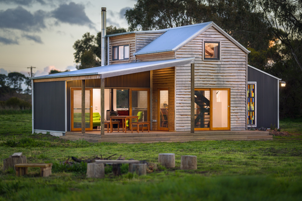 Inspiration for a small eclectic two-storey house exterior with wood siding.