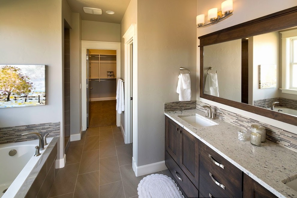 Design ideas for an arts and crafts master bathroom in Boise with an undermount sink, recessed-panel cabinets, dark wood cabinets, granite benchtops, a drop-in tub, an open shower, brown tile and ceramic floors.