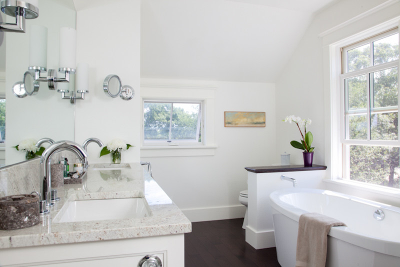 This is an example of a mid-sized traditional master bathroom in Boston with recessed-panel cabinets, white cabinets, a freestanding tub, a two-piece toilet, white walls, an undermount sink and engineered quartz benchtops.