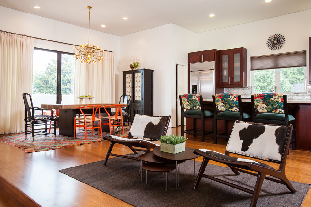 Design ideas for an eclectic open plan dining in Houston with white walls and medium hardwood floors.