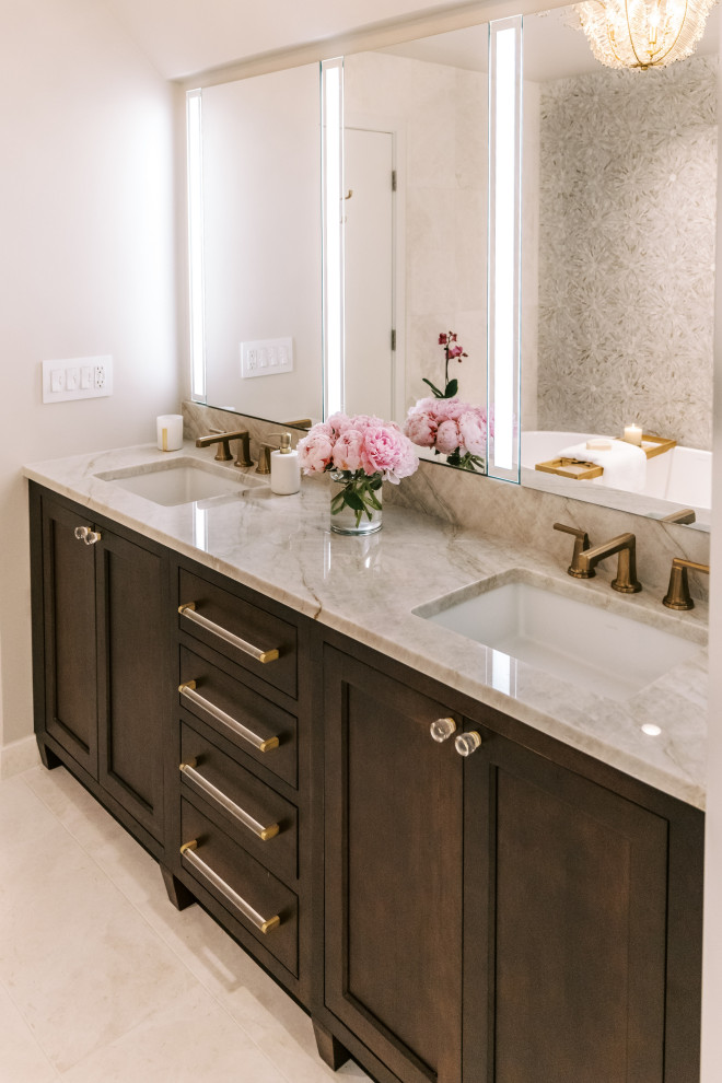 Photo of a contemporary master bathroom in Chicago with recessed-panel cabinets, dark wood cabinets, a freestanding tub, a one-piece toilet, marble, an undermount sink, a hinged shower door, a double vanity and a built-in vanity.