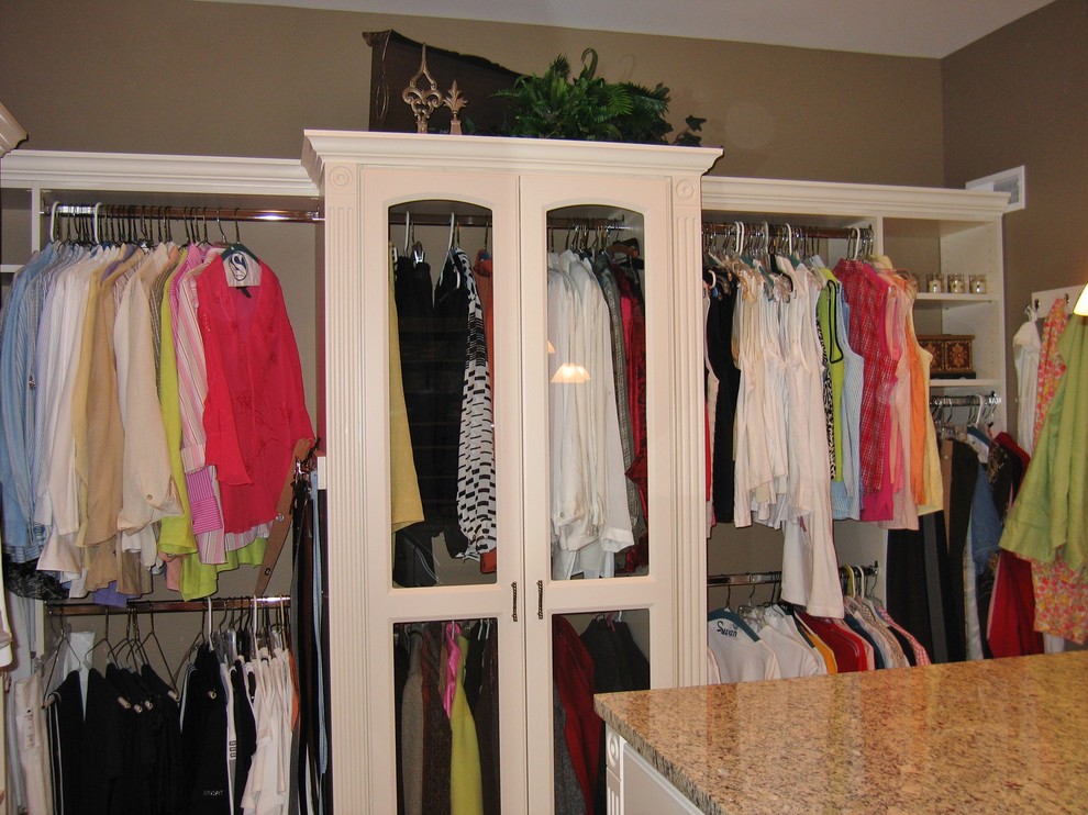 Design ideas for an expansive transitional gender-neutral walk-in wardrobe in Columbus with raised-panel cabinets, beige cabinets and carpet.